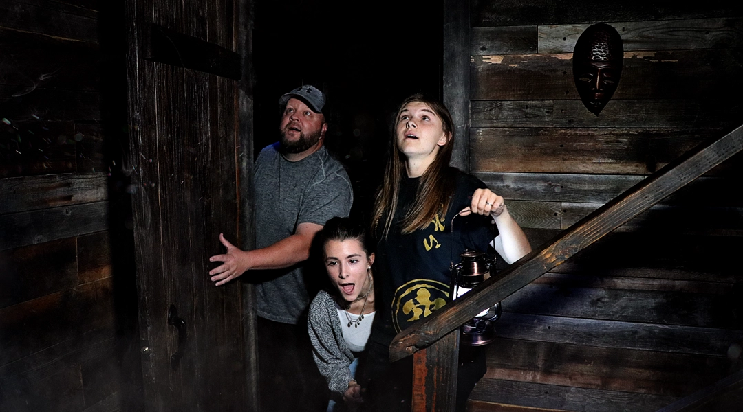 Players exploring the Skull Witch cabin escape room together